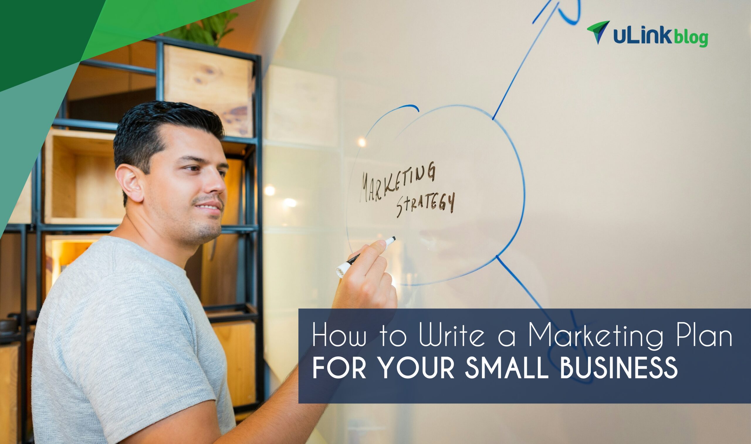 Man in gray crew neck t-shirt stands near wall, having written “Marketing Strategy” in marker on a whiteboard