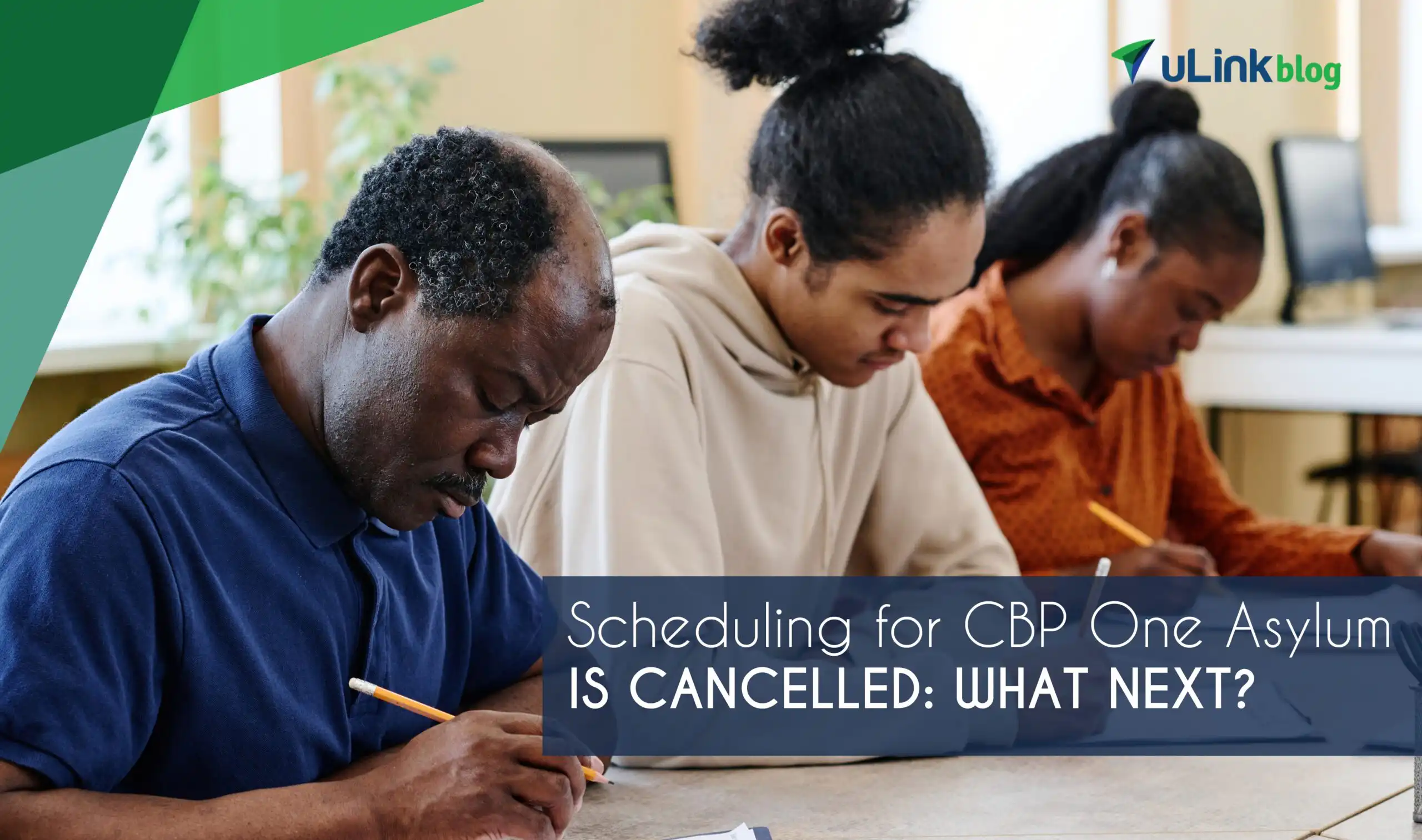 A group of three people are focused on filling out forms.