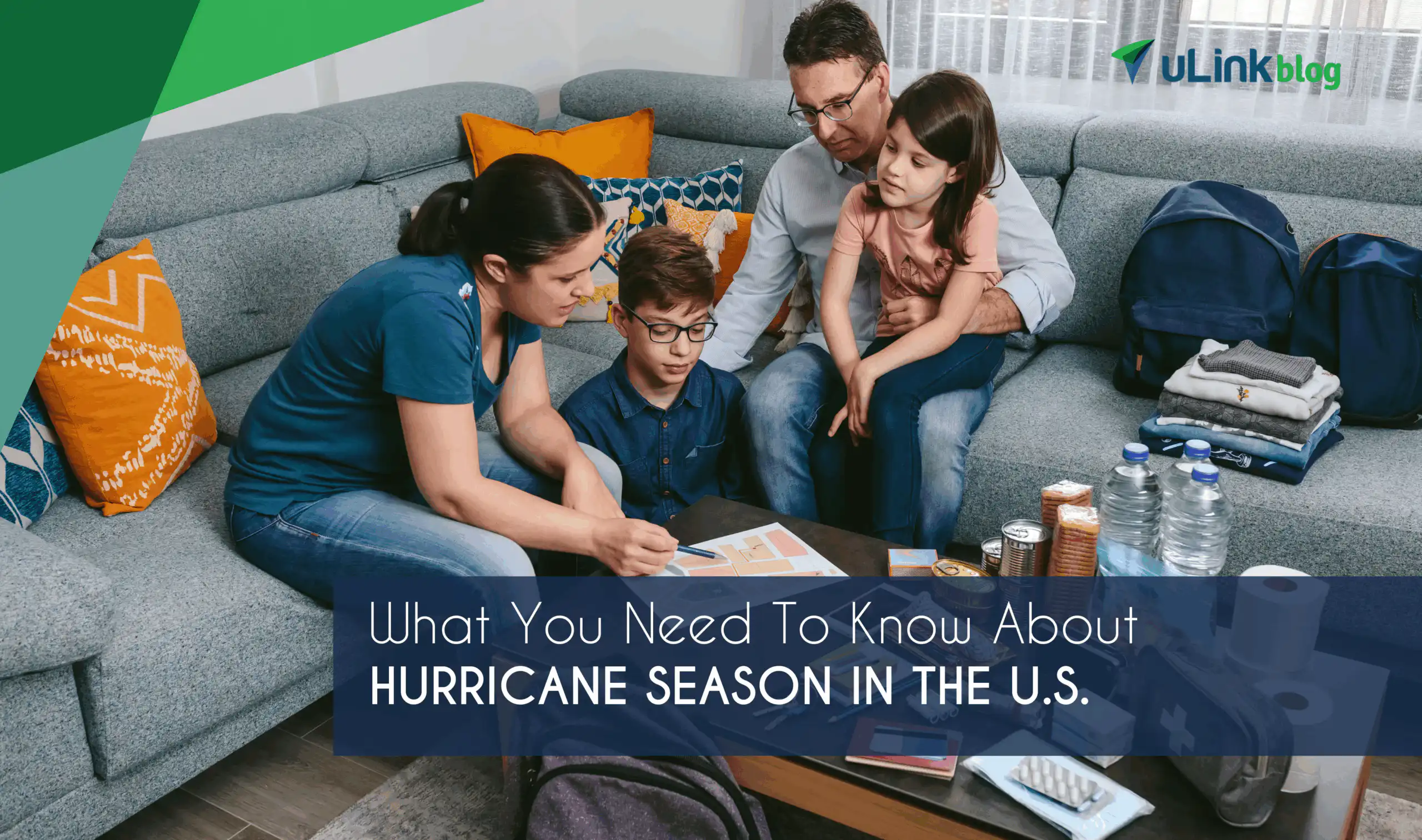A family looking at a map and preparing for an emergency with supplies like water, food, and first aid kit.