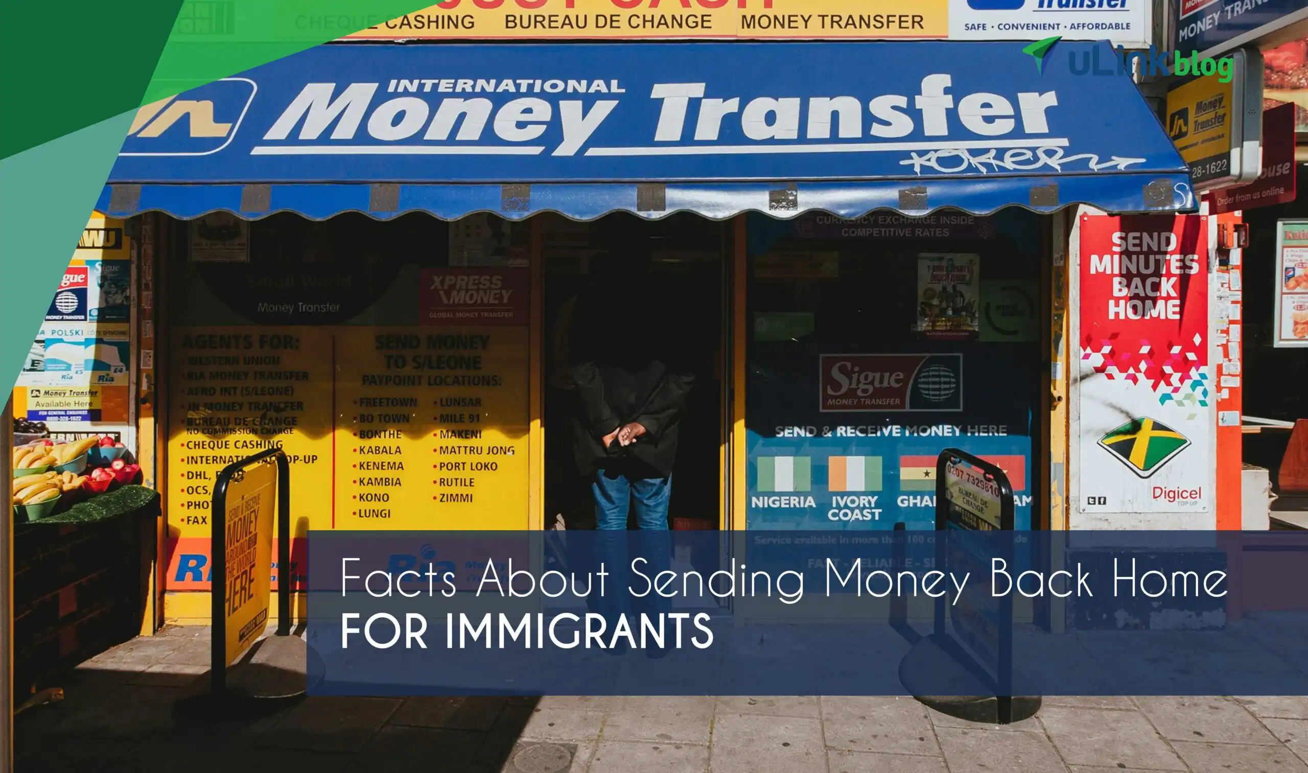 Street view of a storefront with a blue awning reading “International Money Transfer,” featuring signs for various services related to sending money back home