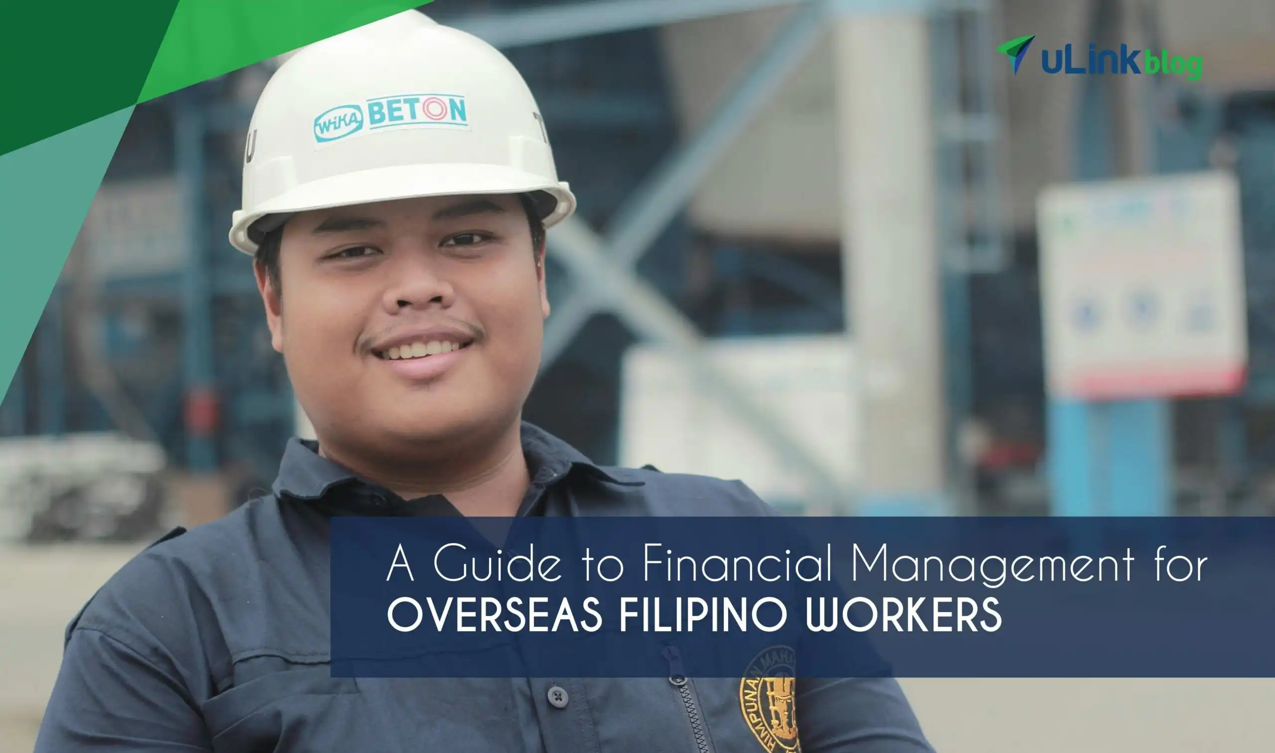 A smiling construction worker wearing a white hard hat and a navy blue uniform.